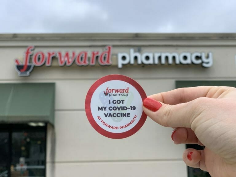 Vaccination sticker in front of Forward Pharmacy location