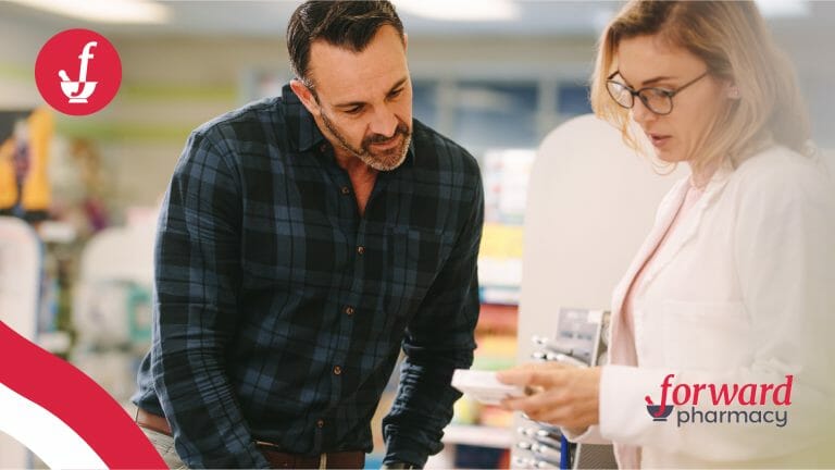 man talking to woman pharmacist while looking at a pill bottle